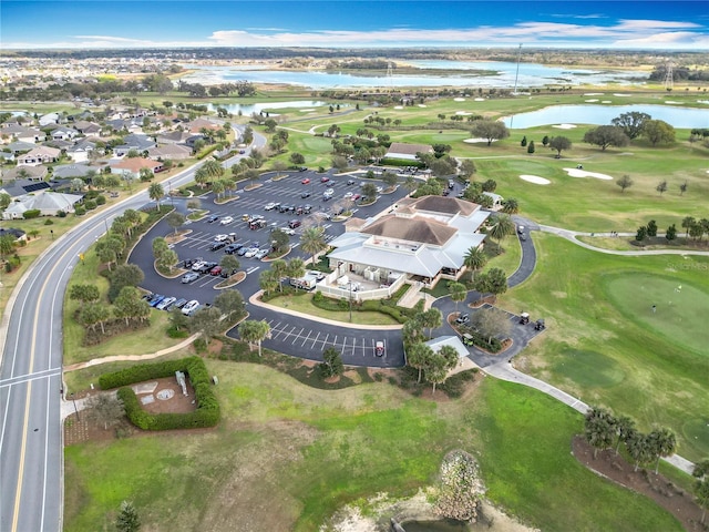 bird's eye view with a residential view, view of golf course, and a water view