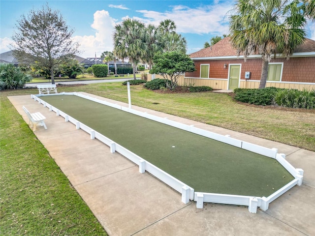 view of property's community with a lawn