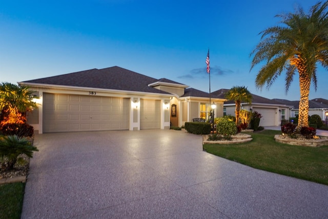 ranch-style home featuring stucco siding, concrete driveway, and a garage