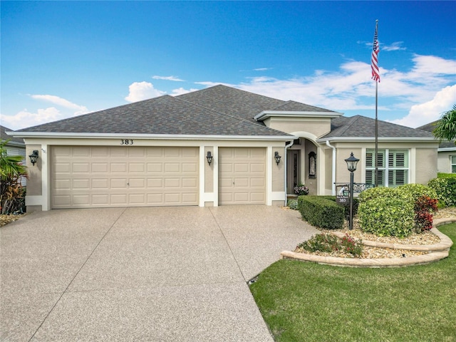 ranch-style home featuring stucco siding, driveway, an attached garage, and a shingled roof