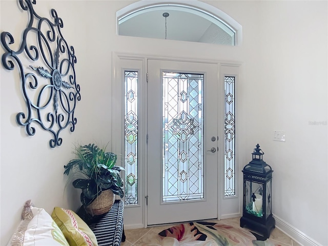 entryway featuring light tile patterned floors and baseboards