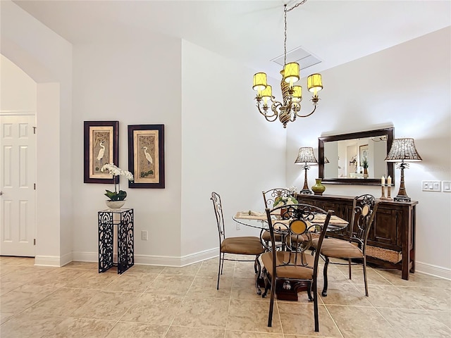 dining space with light tile patterned floors, baseboards, a notable chandelier, and arched walkways