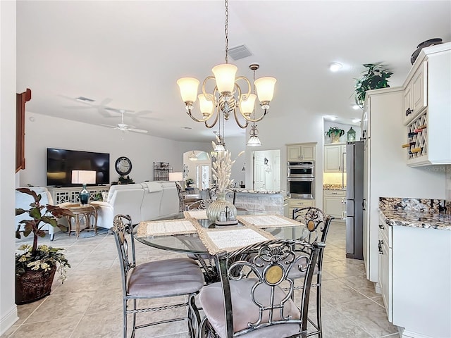 dining space featuring light tile patterned floors, visible vents, and ceiling fan with notable chandelier