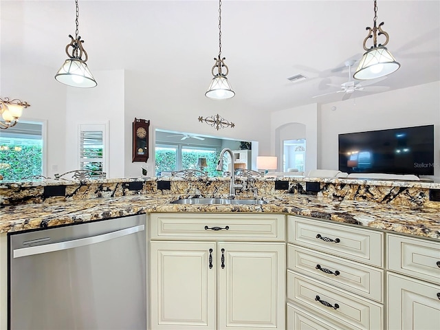 kitchen with pendant lighting, a ceiling fan, a sink, stainless steel dishwasher, and stone counters