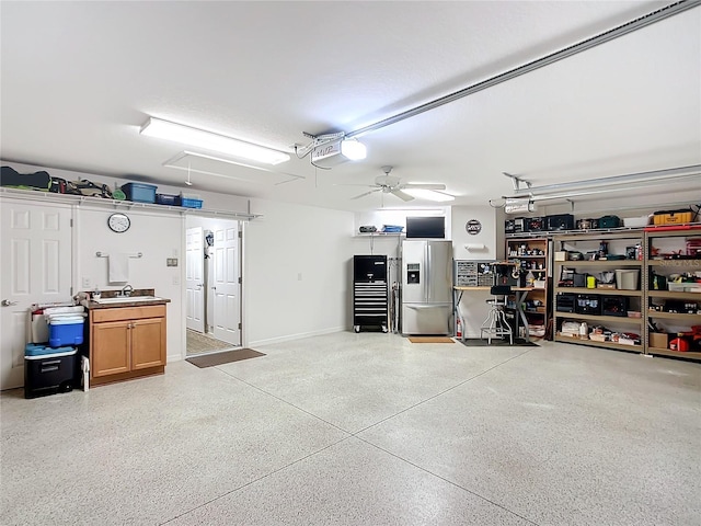 garage featuring a garage door opener, stainless steel fridge with ice dispenser, and a sink