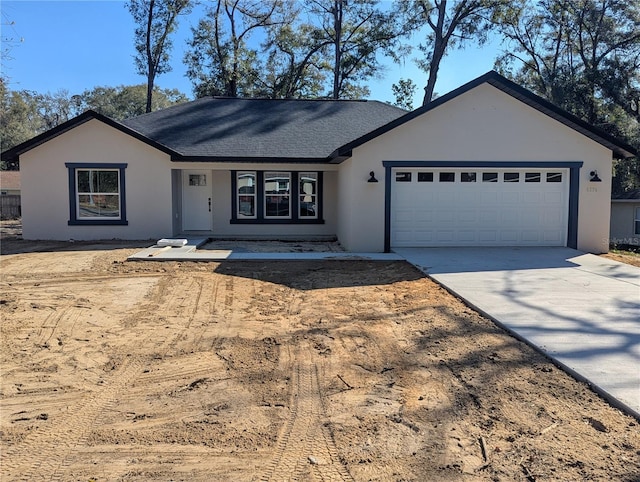 single story home featuring a garage, concrete driveway, a shingled roof, and stucco siding