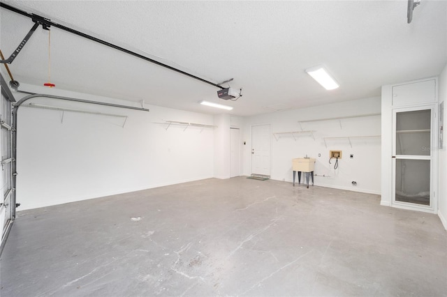 garage featuring a sink and a garage door opener