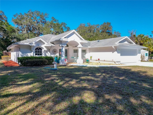 ranch-style house with stucco siding and a front yard