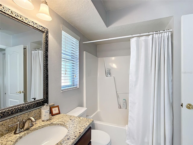 full bath featuring shower / bath combination with curtain, vanity, toilet, and a textured ceiling