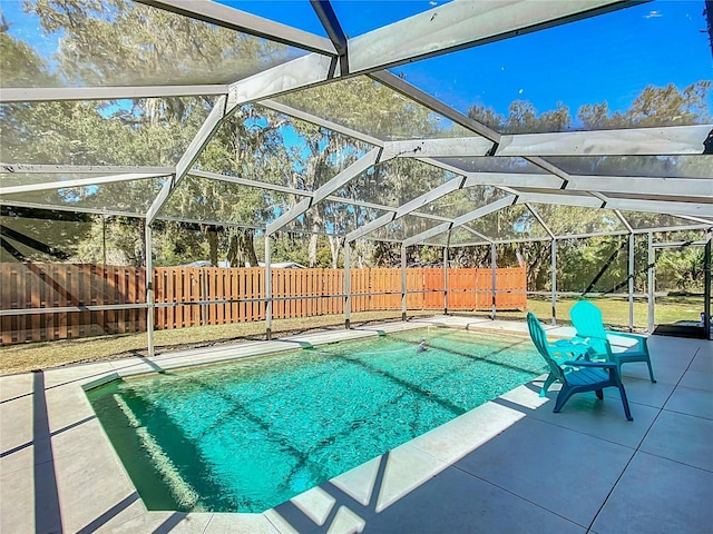 view of swimming pool featuring a patio, a fenced backyard, a lanai, and a fenced in pool