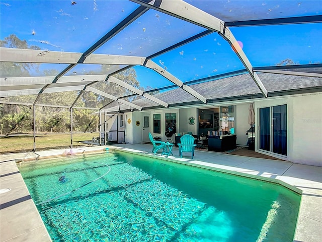 outdoor pool with a patio area and a lanai