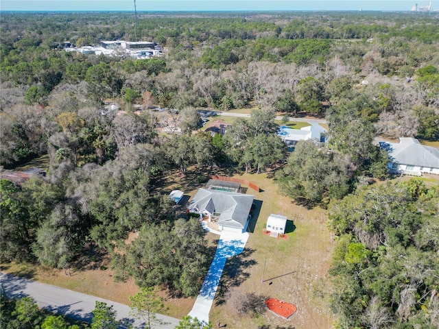 birds eye view of property with a view of trees