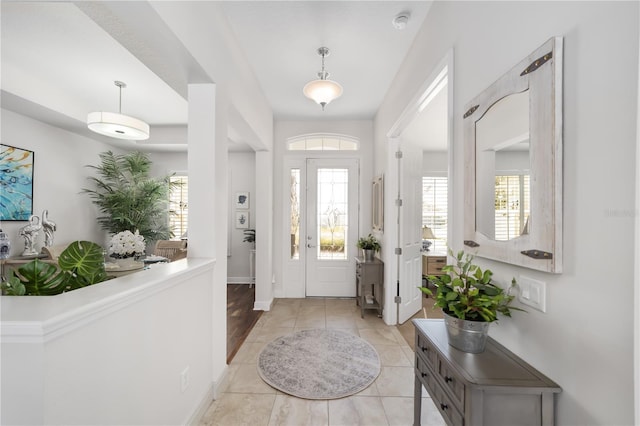 entryway featuring light tile patterned floors and baseboards