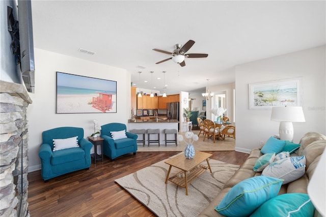 living area with dark wood-style floors, visible vents, baseboards, and ceiling fan with notable chandelier