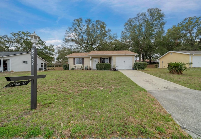 ranch-style house featuring an attached garage, a front yard, and concrete driveway