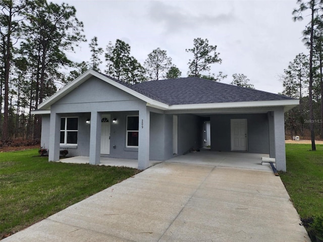 ranch-style house featuring a carport, a shingled roof, concrete driveway, and a front yard