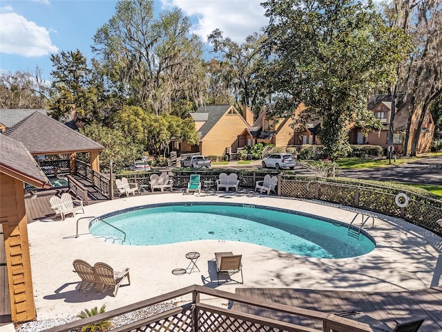 pool with a residential view and fence