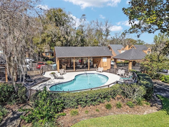 community pool featuring fence, a patio, and a gazebo