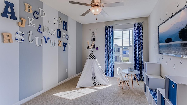 game room with carpet floors, ceiling fan, and baseboards