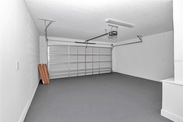 garage with a garage door opener and baseboards