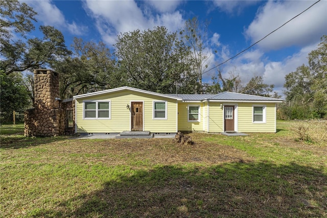 view of front of house featuring metal roof, crawl space, and a front yard