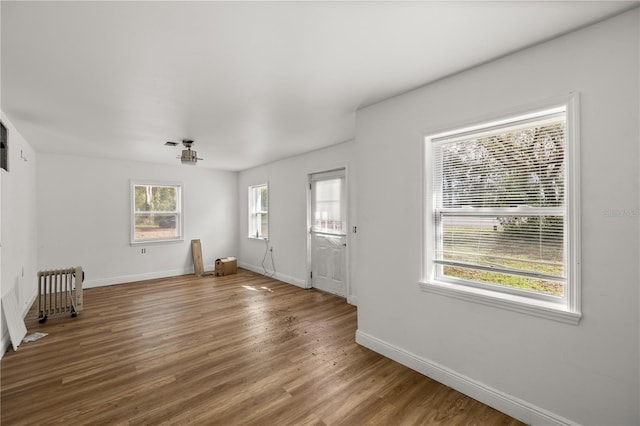 foyer featuring wood finished floors and baseboards