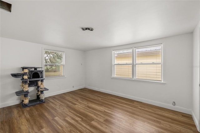 workout room with baseboards and wood finished floors