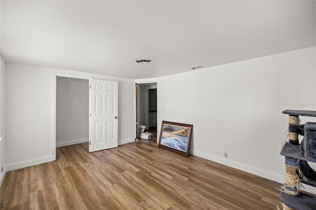 interior space featuring baseboards and wood finished floors