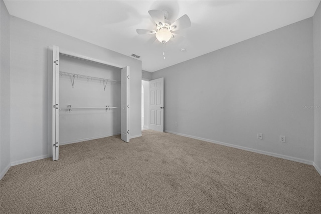 unfurnished bedroom featuring carpet floors, a ceiling fan, visible vents, baseboards, and a closet