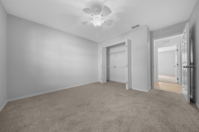 unfurnished bedroom with carpet, a closet, and visible vents