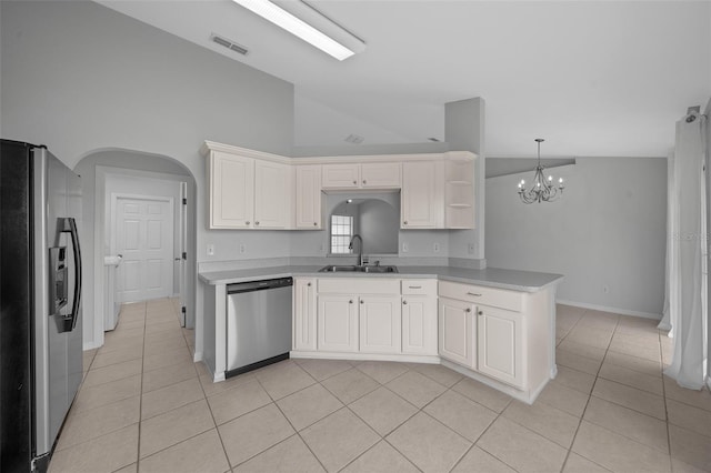 kitchen featuring light tile patterned floors, visible vents, arched walkways, appliances with stainless steel finishes, and a sink