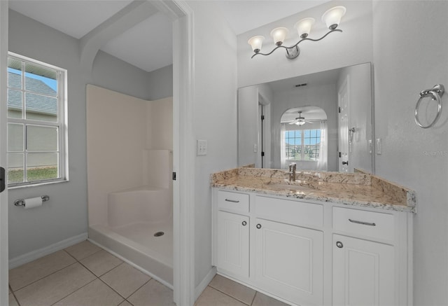 bathroom with baseboards, a shower stall, vanity, and tile patterned floors