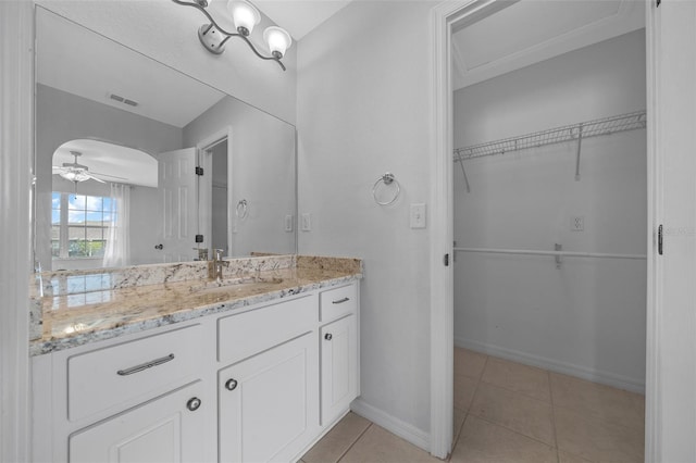 bathroom featuring ceiling fan, tile patterned flooring, vanity, visible vents, and baseboards