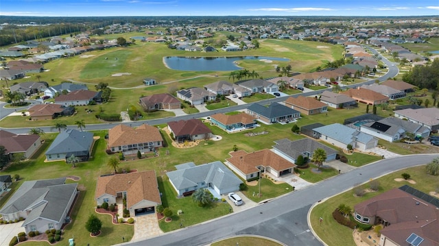 bird's eye view featuring a water view, view of golf course, and a residential view