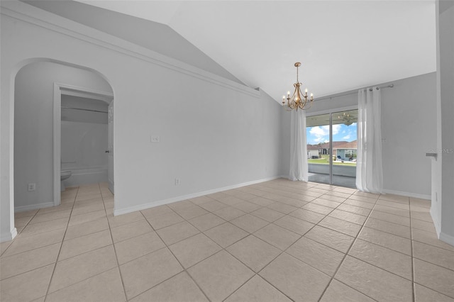 empty room with light tile patterned floors, arched walkways, a chandelier, baseboards, and vaulted ceiling