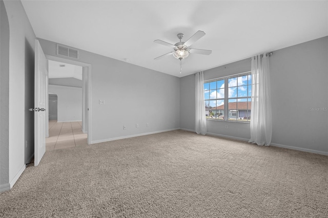 unfurnished room featuring light colored carpet, ceiling fan, visible vents, and baseboards