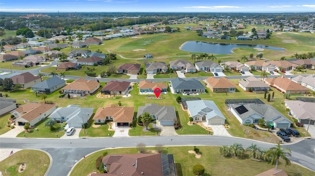 bird's eye view with a water view, view of golf course, and a residential view