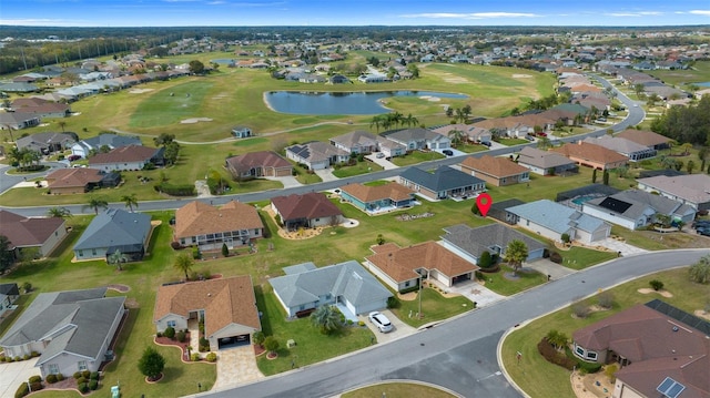 drone / aerial view with a water view, view of golf course, and a residential view