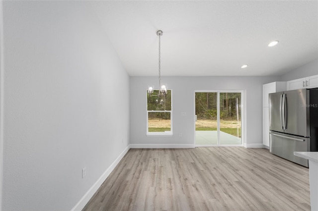 unfurnished dining area featuring a chandelier, light wood-style floors, recessed lighting, and baseboards