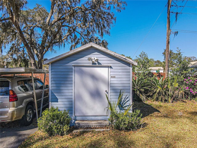 view of shed featuring fence