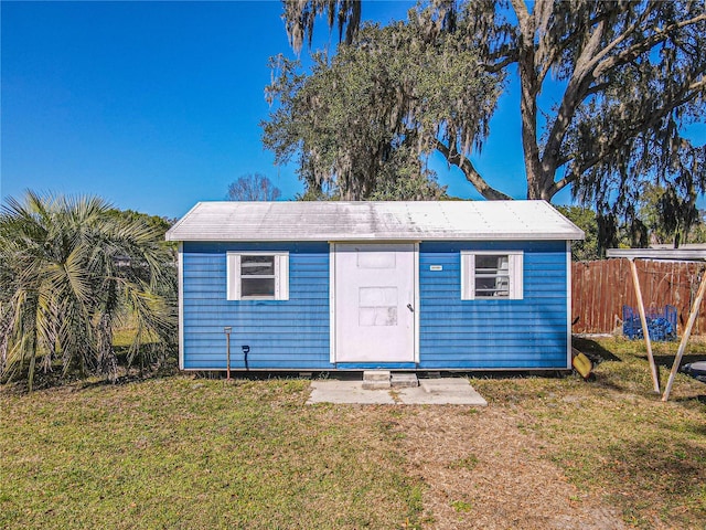 view of shed featuring fence