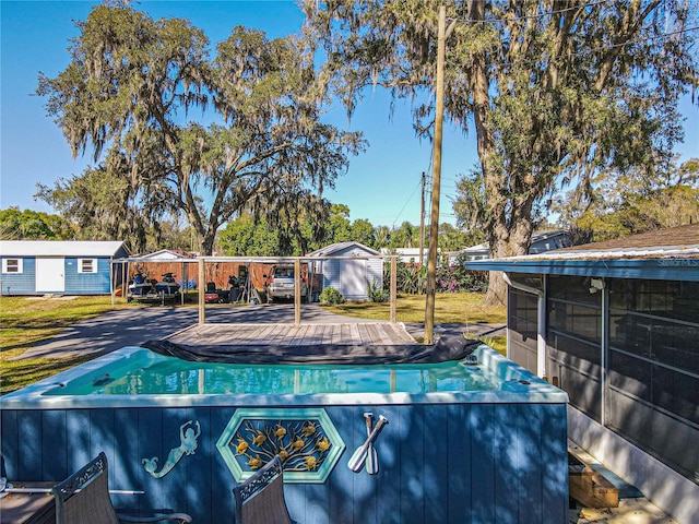 view of pool featuring a sunroom