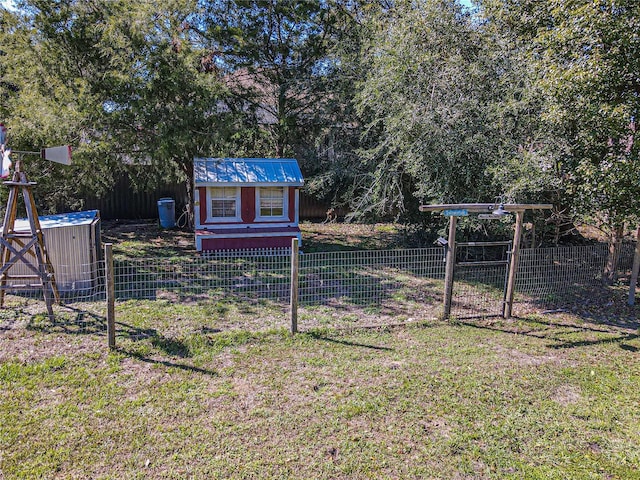 view of yard with an outbuilding, central air condition unit, fence, and a shed