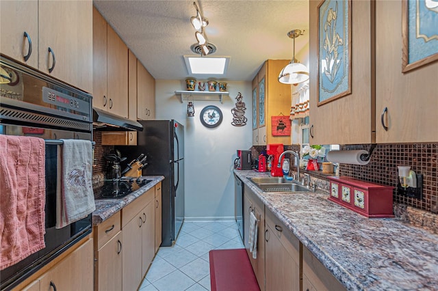 kitchen featuring a sink, under cabinet range hood, black appliances, pendant lighting, and backsplash