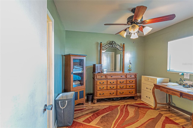 office with a ceiling fan and wood finished floors