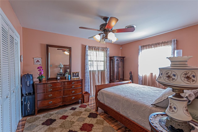 bedroom with ceiling fan, a closet, and wood finished floors