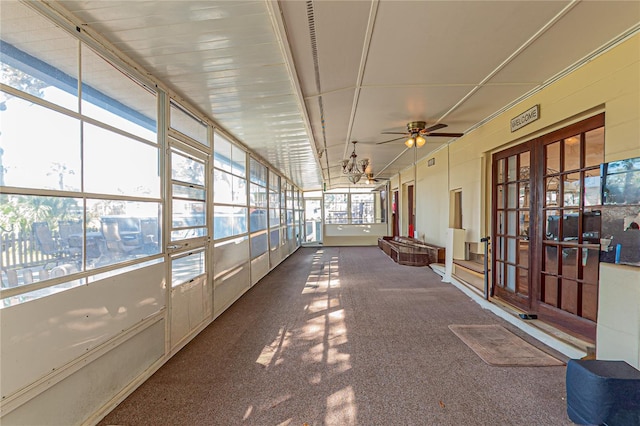 unfurnished sunroom featuring ceiling fan