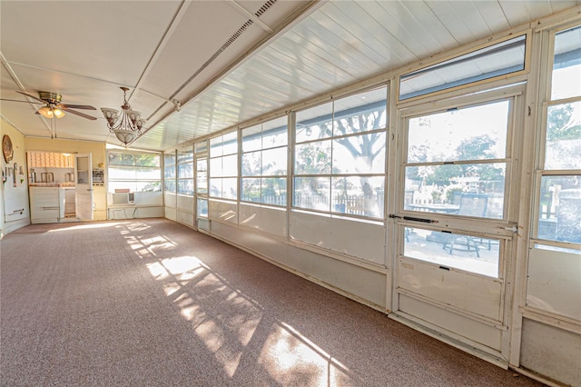 unfurnished sunroom with a ceiling fan