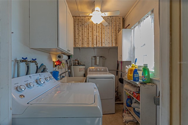 laundry room with a sink, a ceiling fan, water heater, cabinet space, and washer and clothes dryer