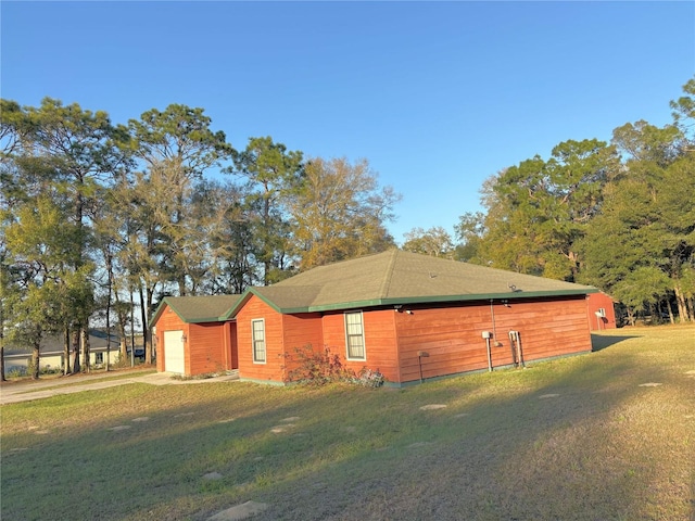 view of property exterior featuring a garage, a lawn, and concrete driveway